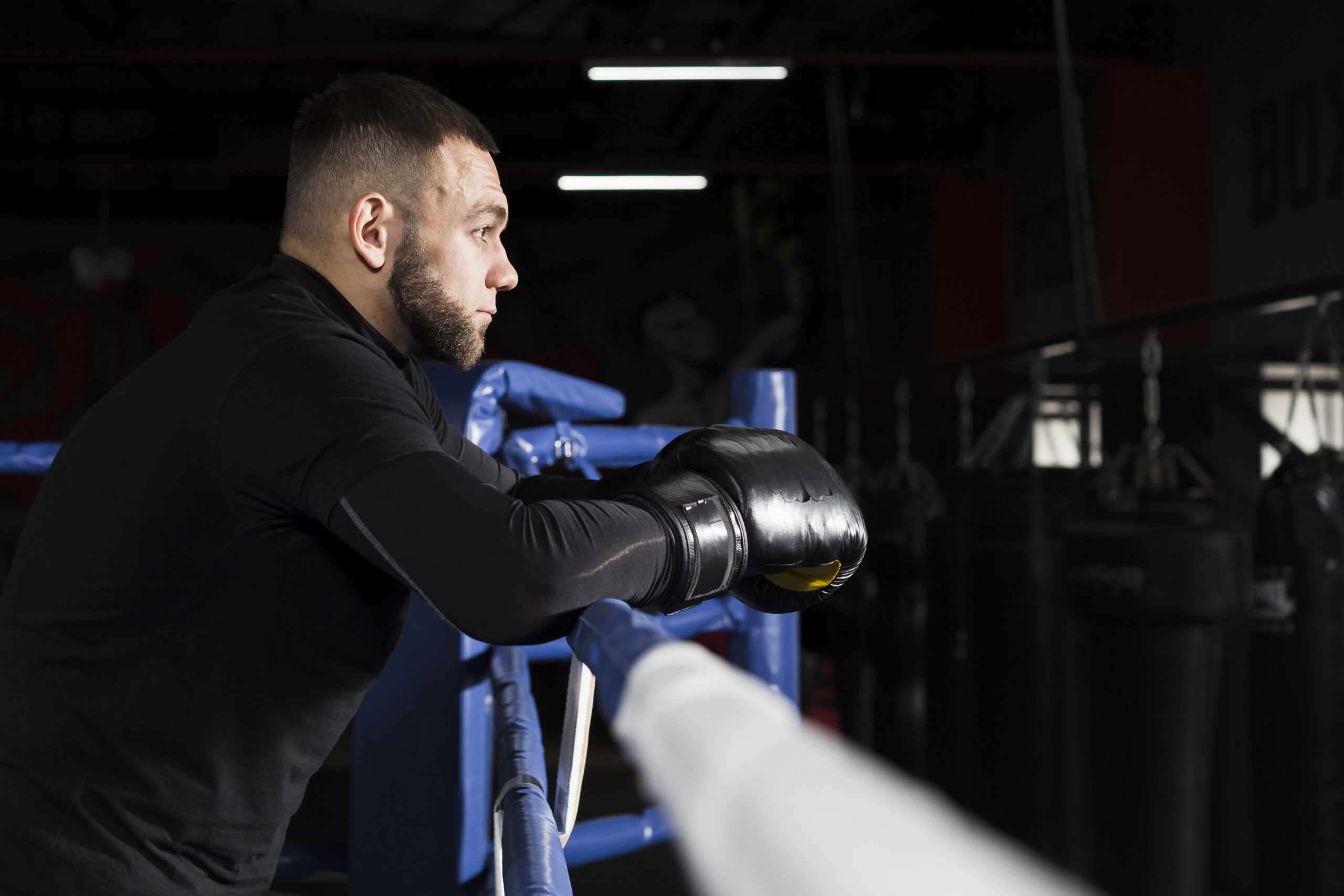 side view man wearing boxing gloves